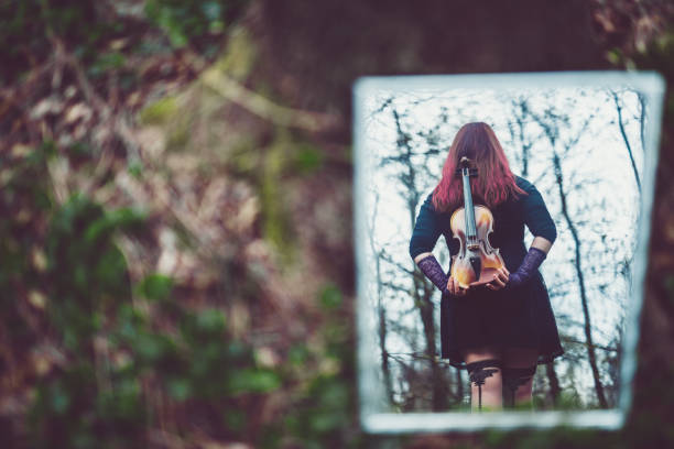 istock Goth girl with fiddle, reflection 1010099760