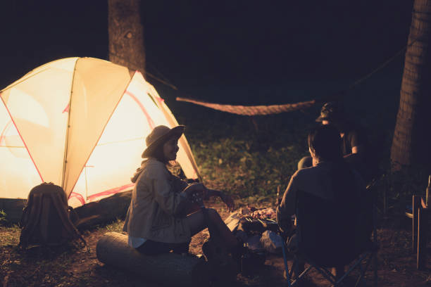 istock Friends are camping in the woods at night. 1010105404