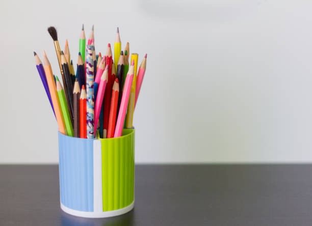 istock colored pencils and pens in a glass on the table 1010109300