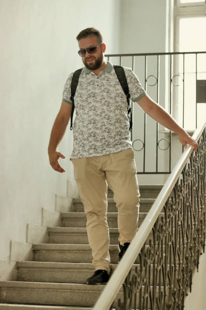 istock Young bearded man climbing stairs 1010110234