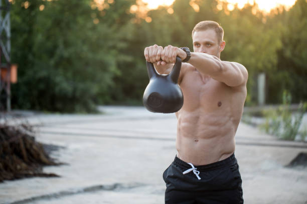 istock Handsome man exercising weightlifting a kettle bell 1010115042