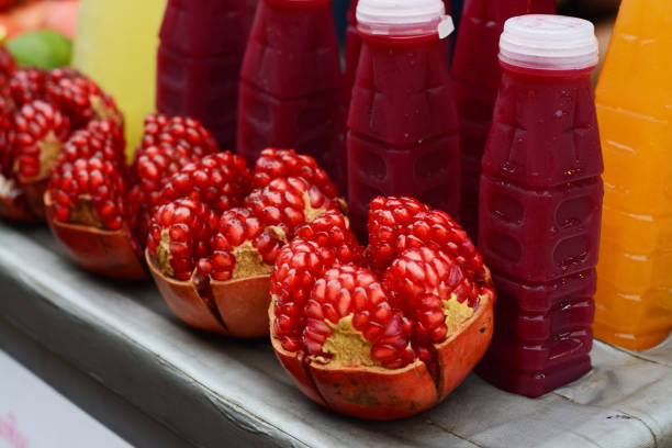 Fresh Red pomegranate fruit, and Red pomegranate Juice in market