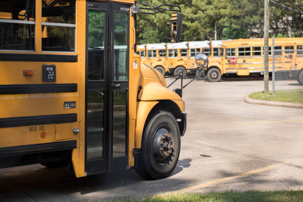 istock Back to School:  School buses in a row at the bus barn. 1010118822