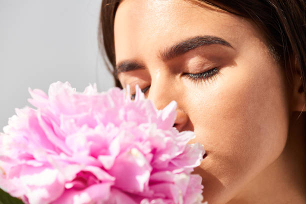 istock Girl Enjoying Scent Of Peony 1010119988