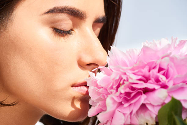 istock Young Woman Smelling Flowers 1010119996