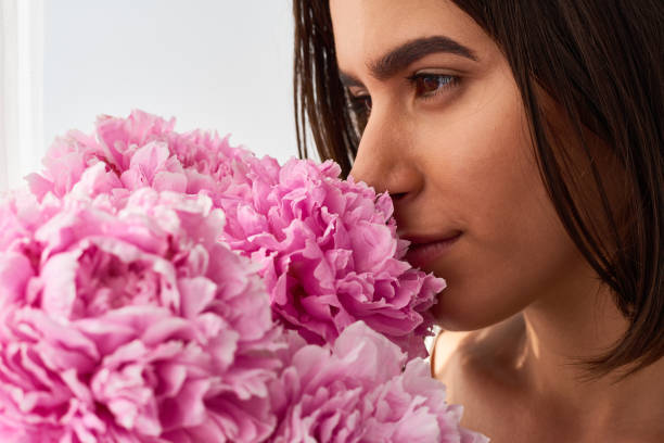 istock Dreamy Girl Smelling Peonies 1010123488
