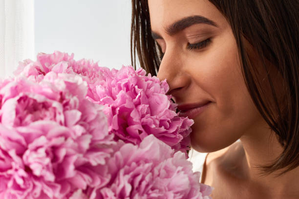 istock Dreamy Girl Smelling Peonies 1010123584
