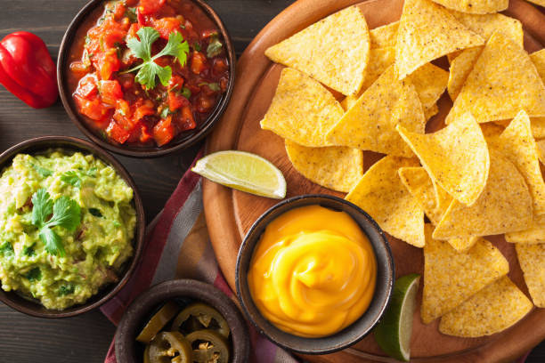 istock mexican nachos tortilla chips with guacamole, salsa and cheese dip 1010128588