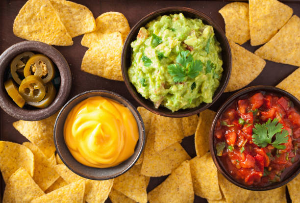 istock mexican nachos tortilla chips with guacamole, salsa and cheese dip 1010129344