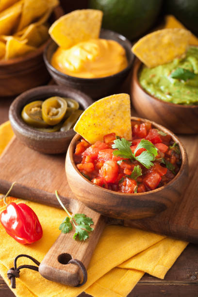 istock mexican nachos tortilla chips with guacamole, salsa and cheese dip 1010129646