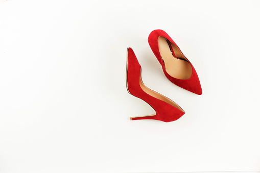 Fashion blog look. Women red high heel shoes on white background. Flat lay, top view trendy beauty female background.