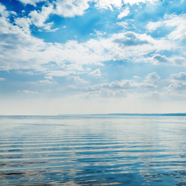 water in river close up and blue sky with clouds