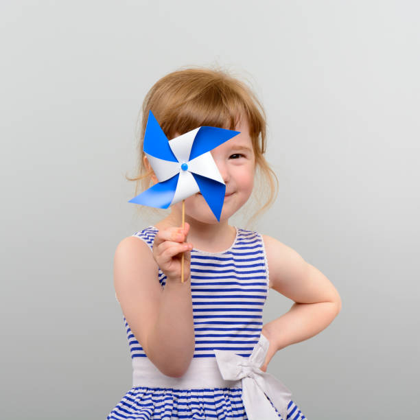 Cute girl with windmill toy stock photo