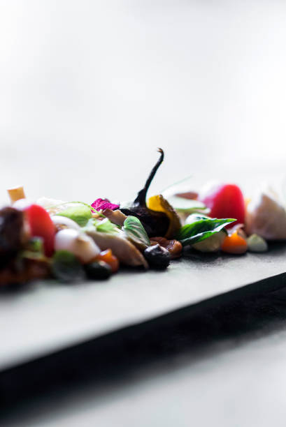 modern gourmet creative cuisine goat cheese salad with organic marinated vegetables and figs