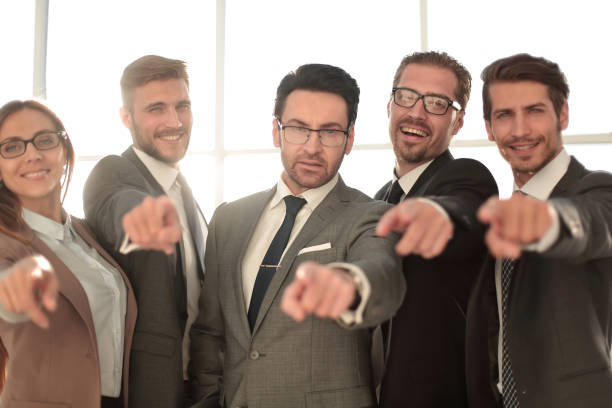 istock Smiling Diverse Business Team Pointing at You 1010151098