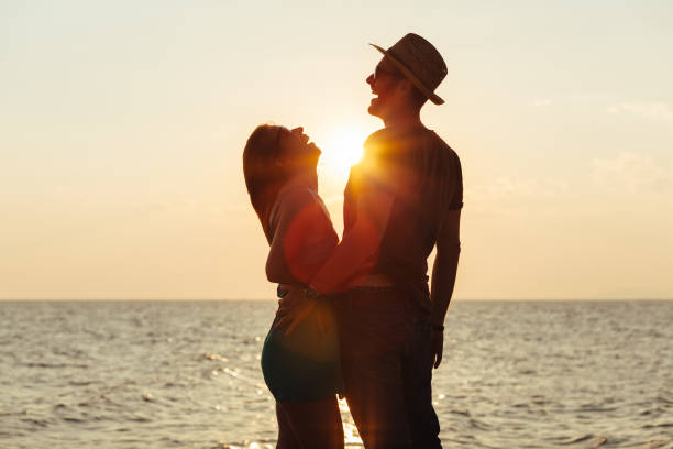 istock Young couple in love enjoying sunset on the beach 1010151904