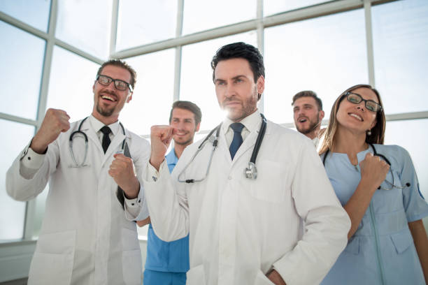 istock Smiling doctors, pumping fists and celebrating success 1010154344