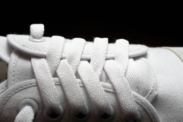 istock Closed-up photo of white sneaker on dark background. 1010154532