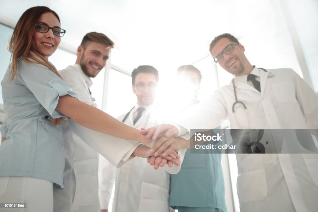 Doctors and nurses coordinate hands Teamwork in hospital for success work and trust in team Doctor Stock Photo