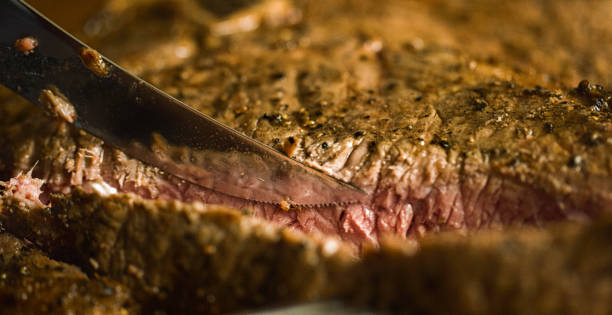 istock A Knife Cuts into a Grilled T-Bone Beef Steak 1010160450