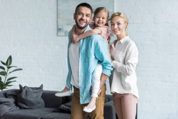 istock happy family smiling at camera while spending time together at home 1010160630