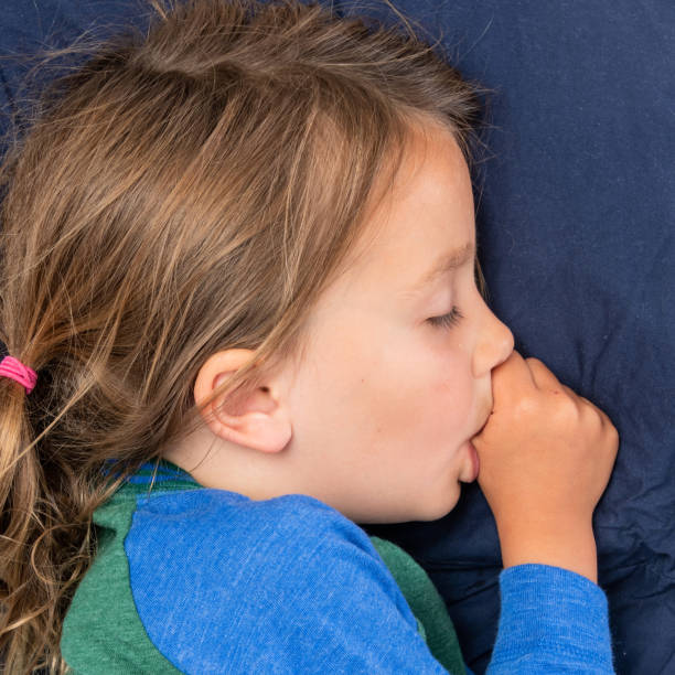 istock little girl sleeping sucking her thumb 1010168810