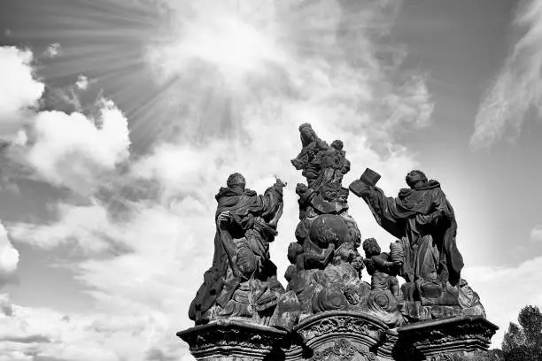 Photo of Virgin Mary statue at the Charles Bridge (Karluv Most) in Prague, Czech Republic. Close up view. Black and white