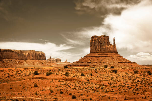 Sandstone Buttes of Monument Valley Monument Valley, a red-sand desert region on the Arizona-Utah border, is known for the towering sandstone buttes of Monument Valley Navajo Tribal Park. west mitten stock pictures, royalty-free photos & images