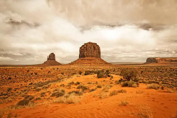 Monument Valley, a red-sand desert region on the Arizona-Utah border, is known for the towering sandstone buttes of Monument Valley Navajo Tribal Park.