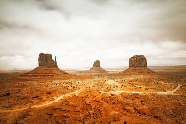 Magnificent landscape view of Monument Valley at sunset Monument Valley, a red-sand desert region on the Arizona-Utah border, is known for the towering sandstone buttes of Monument Valley Navajo Tribal Park. west mitten stock pictures, royalty-free photos & images