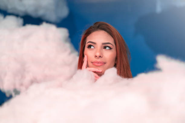 istock Woman Contemplation at clouds on background 1010177074