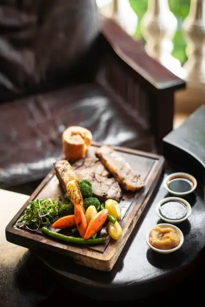 Photo of gourmet sunday roast beef traditional british meal set on old wooden pub table