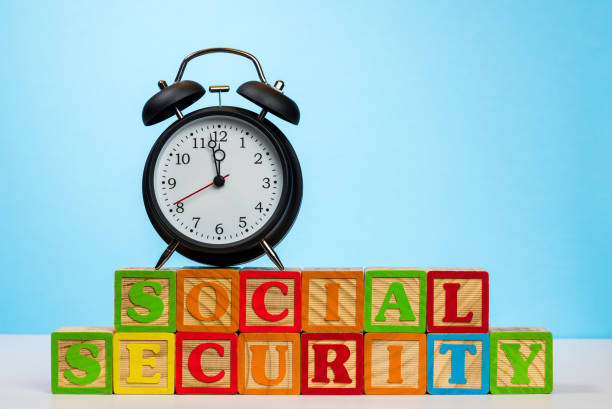 istock Alarm clock on wooden blocks for Social Security 1010185512
