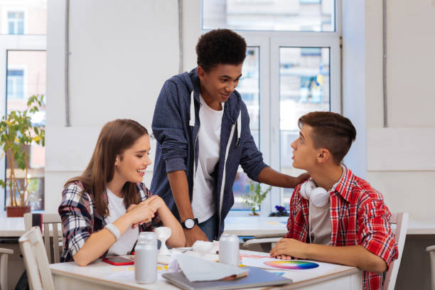 istock Handsome student wearing white wrist watch coming to his colleagues 1010197972