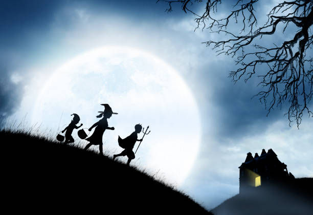 istock Three Children Dressed Up For Halloween Silhouetted Against Moon 1010201912