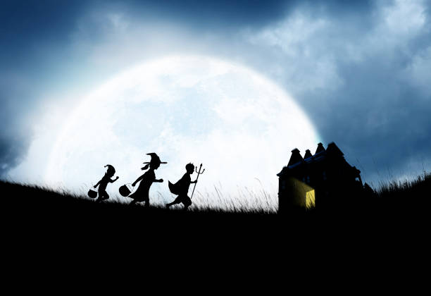 istock Three Children Dressed Up For Halloween Silhouetted Against Moon 1010201946
