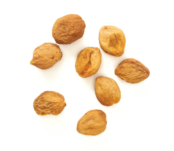 istock Yellow sun dried apricots isolated on white background. Top view. 1010207652