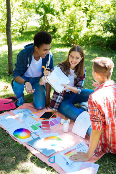 istock Three positive smiling students spending their time in nature 1010207790