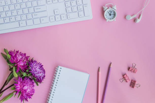 istock Blogger or freelancer workspace with notebook and pink flowers 1010208552