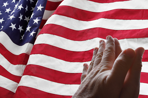 American flag and praying hands