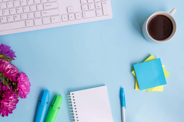 istock Blogger or freelancer workspace with notebook and pink flowers 1010210792