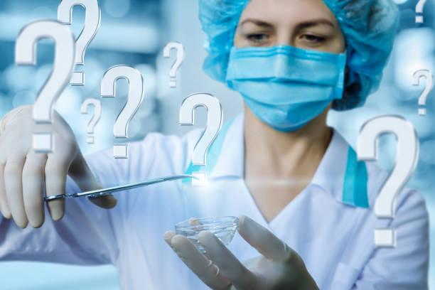 istock A medical worker in the clamp holding the question mark. 1010214820