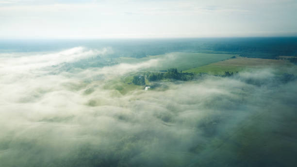 istock Misty sunrise over countryside path Aerial view Latvia 1010215812