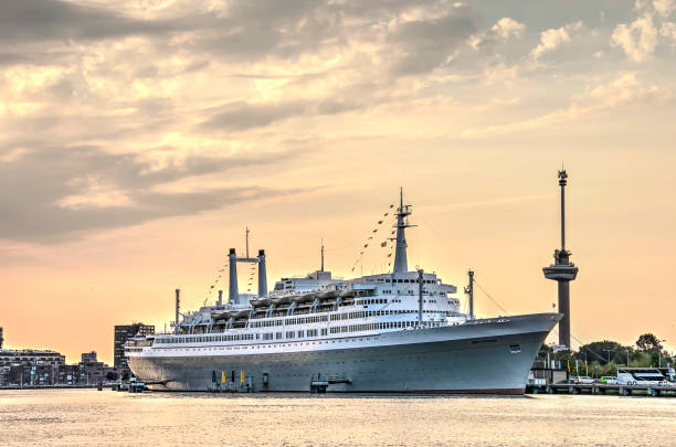 Rotterdam, The Netherlands, July 16, 2018: two tourist attractions, Euromast observation tower and former cruiseship SS Rotterdam under a dramatic evening sky