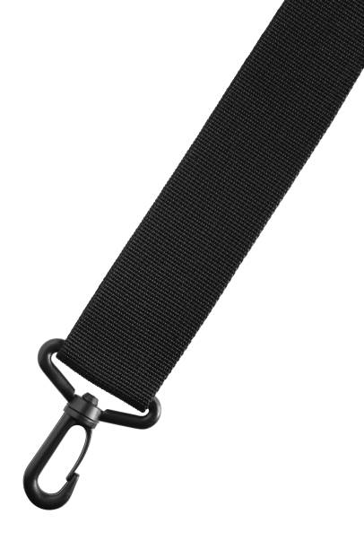 Black belt rope strap lanyard, hanging plastic clasp snap latch hook carabiner, isolated macro closeup, large detailed vertical diagonal studio shot Black belt rope strap lanyard, hanging plastic clasp snap latch hook carabiner, isolated macro closeup, large detailed vertical diagonal studio shot lace fastener photos stock pictures, royalty-free photos & images