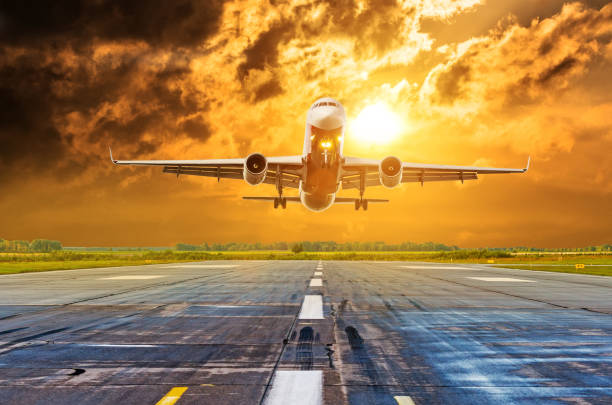 istock Commercial airplane flying runway airport above dramatic clouds. 1010231082
