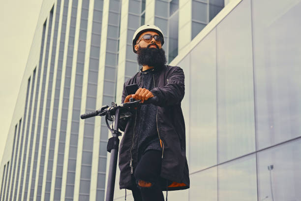 istock A man riding by electric scooter and using a smart phone. 1010234678