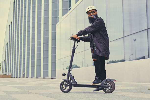 istock A man vaping and riding by electric scooter. 1010236920