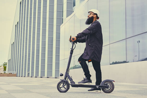 istock A man vaping and riding by electric scooter. 1010238194