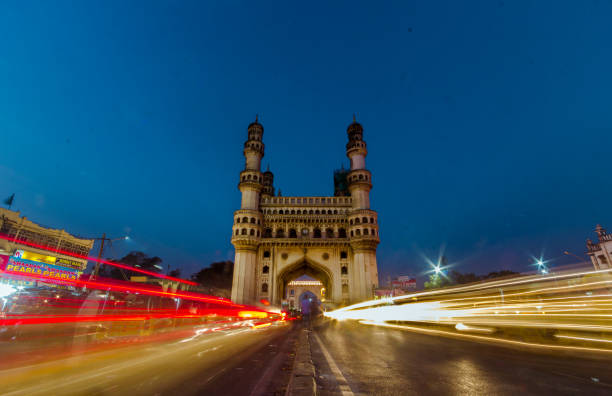 The Spectacular Char Minar during the blue hour Red and Yellow light trails cut across the charminar of Hyderabad as the sun dips down. blue hour twilight stock pictures, royalty-free photos & images